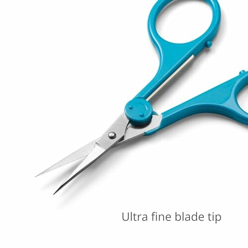 Blue-handled scissors with ultra fine blade tip