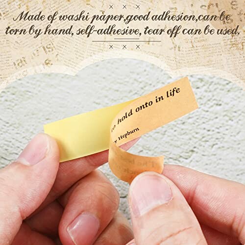 Hands tearing washi paper with text.