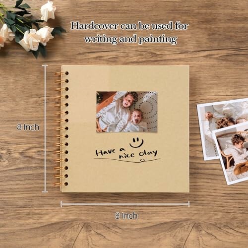 Hardcover photo album on a wooden table with photos