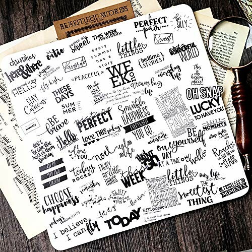 Collection of inspirational word stickers on a sheet with a magnifying glass and papers.