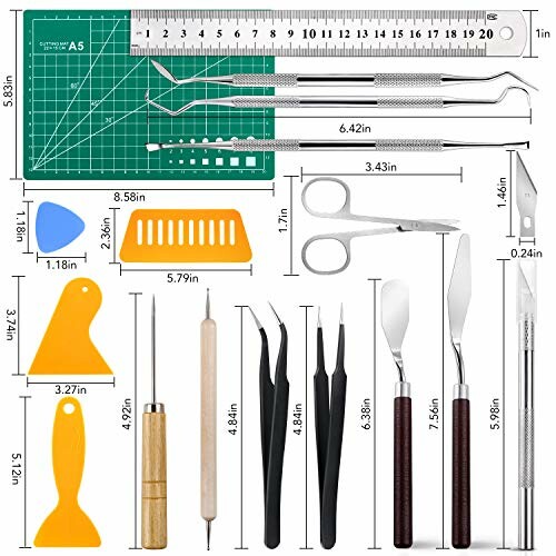 Precision tool set with cutting mat, rulers, tweezers, and various tools.