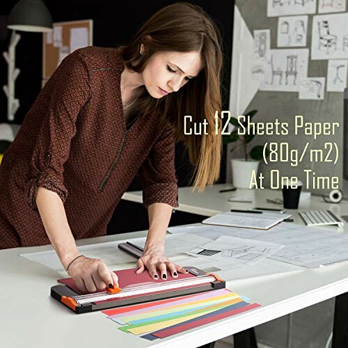 Woman using a paper cutter in an office setting.